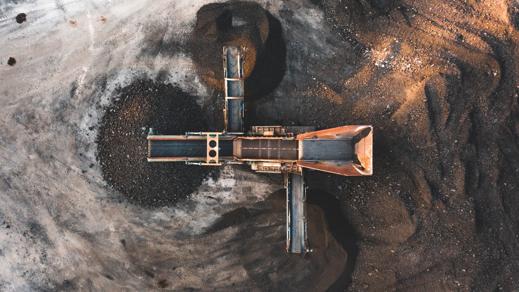 Aerial View of Heavy Equipment Machine working the dirt Aerial View of Heavy Equipment Machine working the dirt